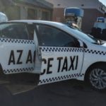 A white taxi with its back doors open